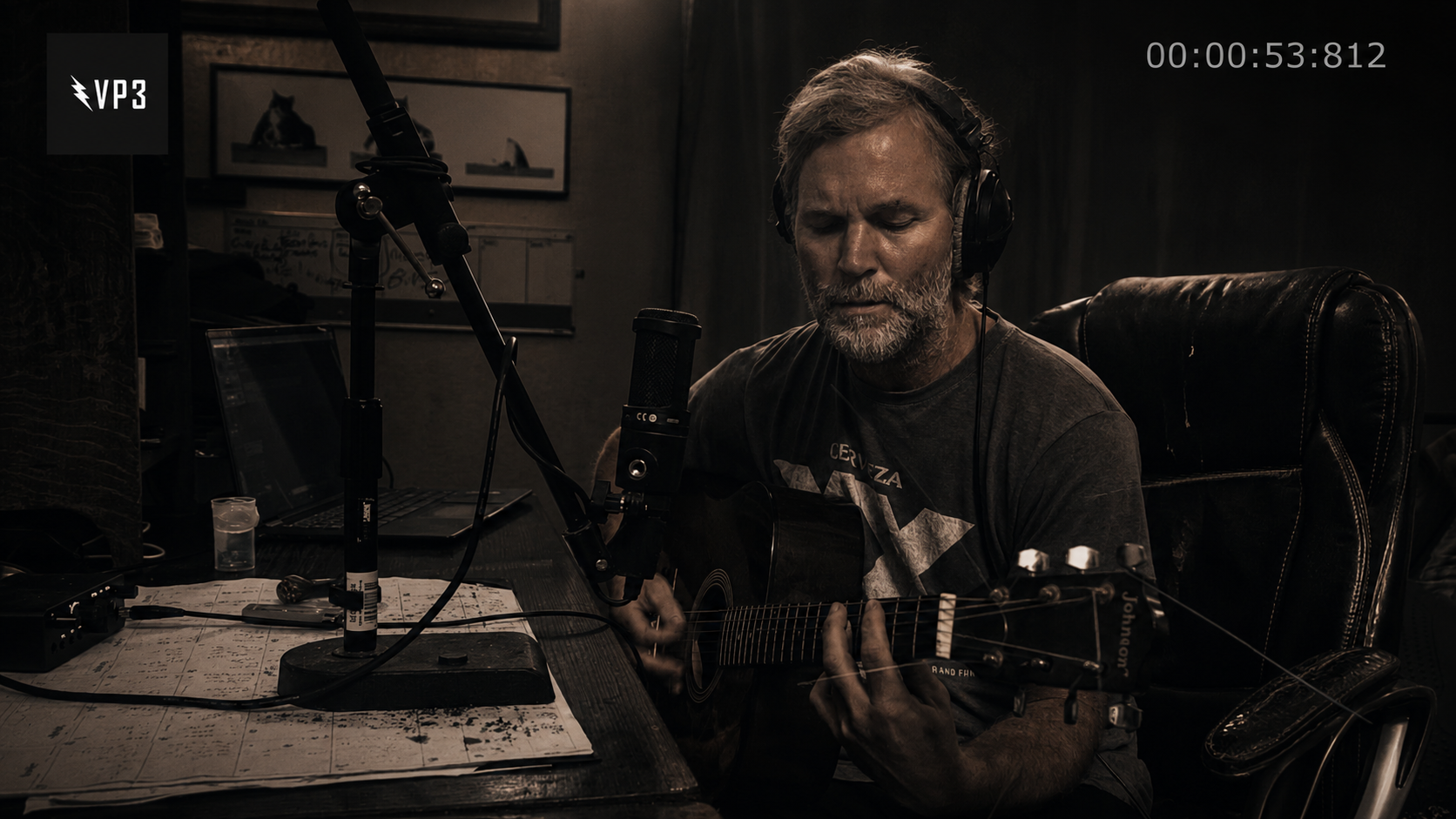 Stonefellow recording acoustic guitar in a dark studio